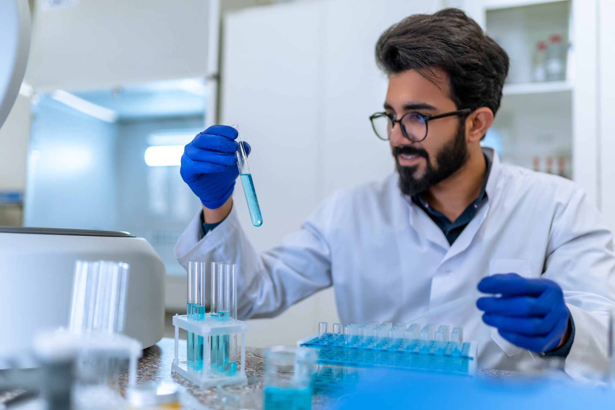 Scientist examining test tube in laboratory.