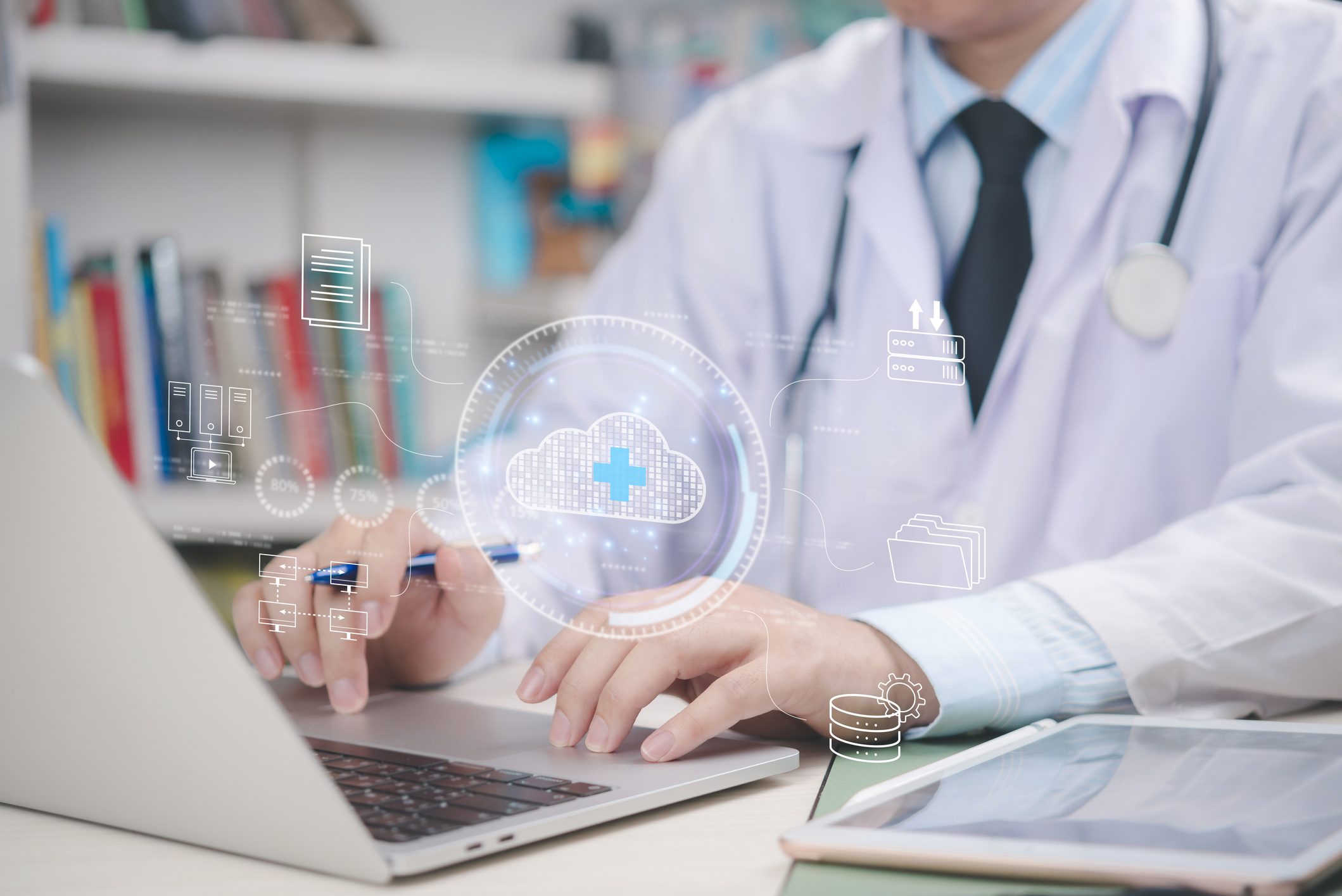 Doctor using laptop with digital healthcare icons.