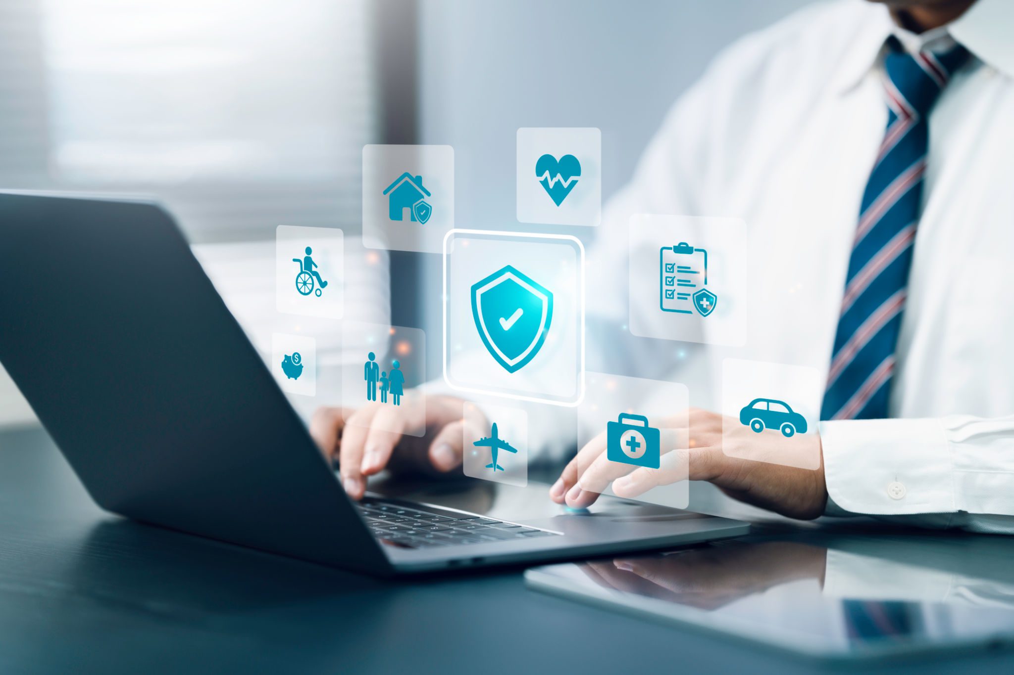 Man using laptop with digital security icons.