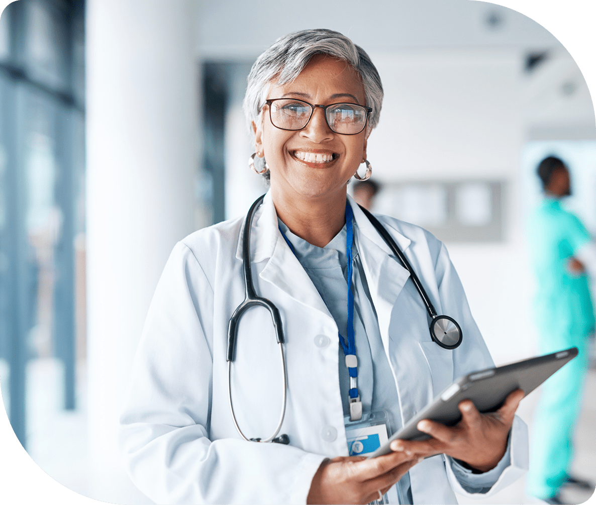 Smiling doctor holding a digital tablet.